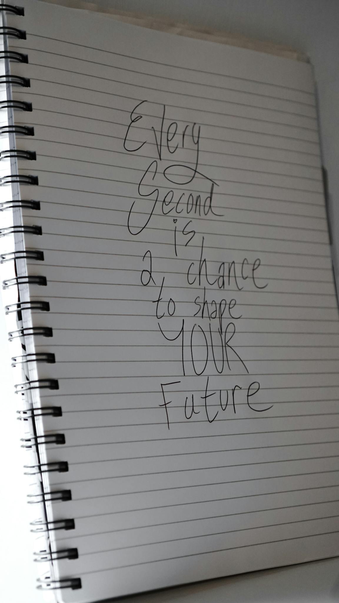 An open notebook with a handwritten motivational quote inspires future possibilities.